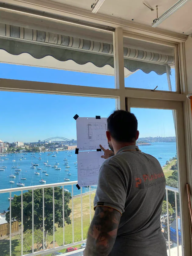 Checking drainage and plumbing plans on site above the harbour