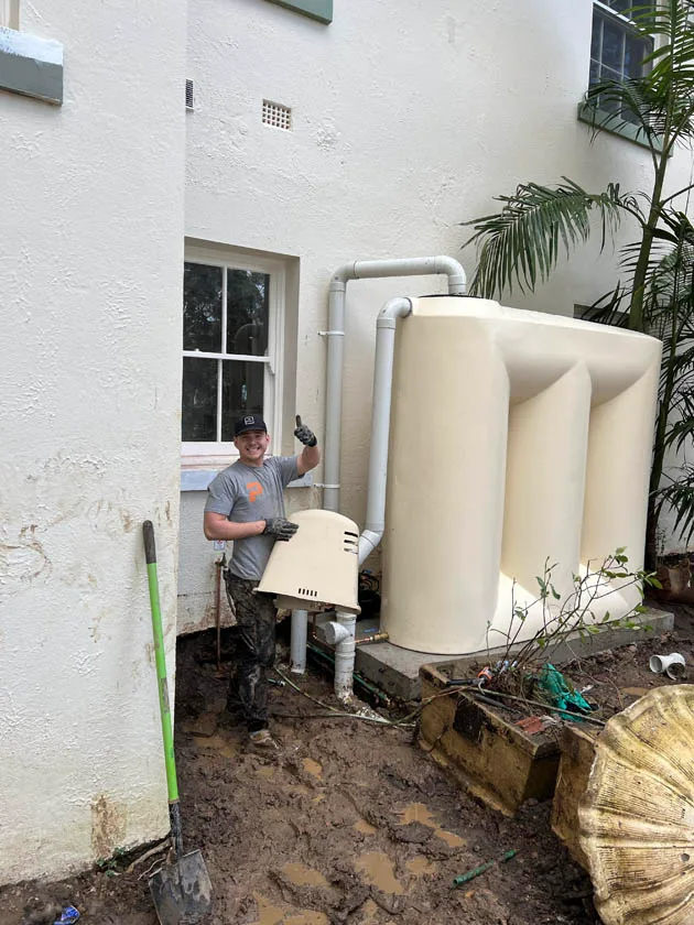 Finishing a rainwater tank plumbing connection at a house